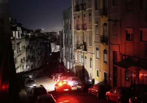 cars parked cars on a street at night