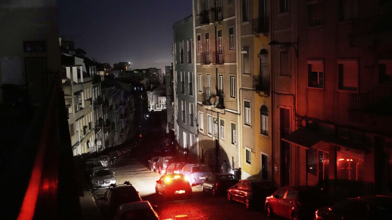 cars parked cars on a street at night