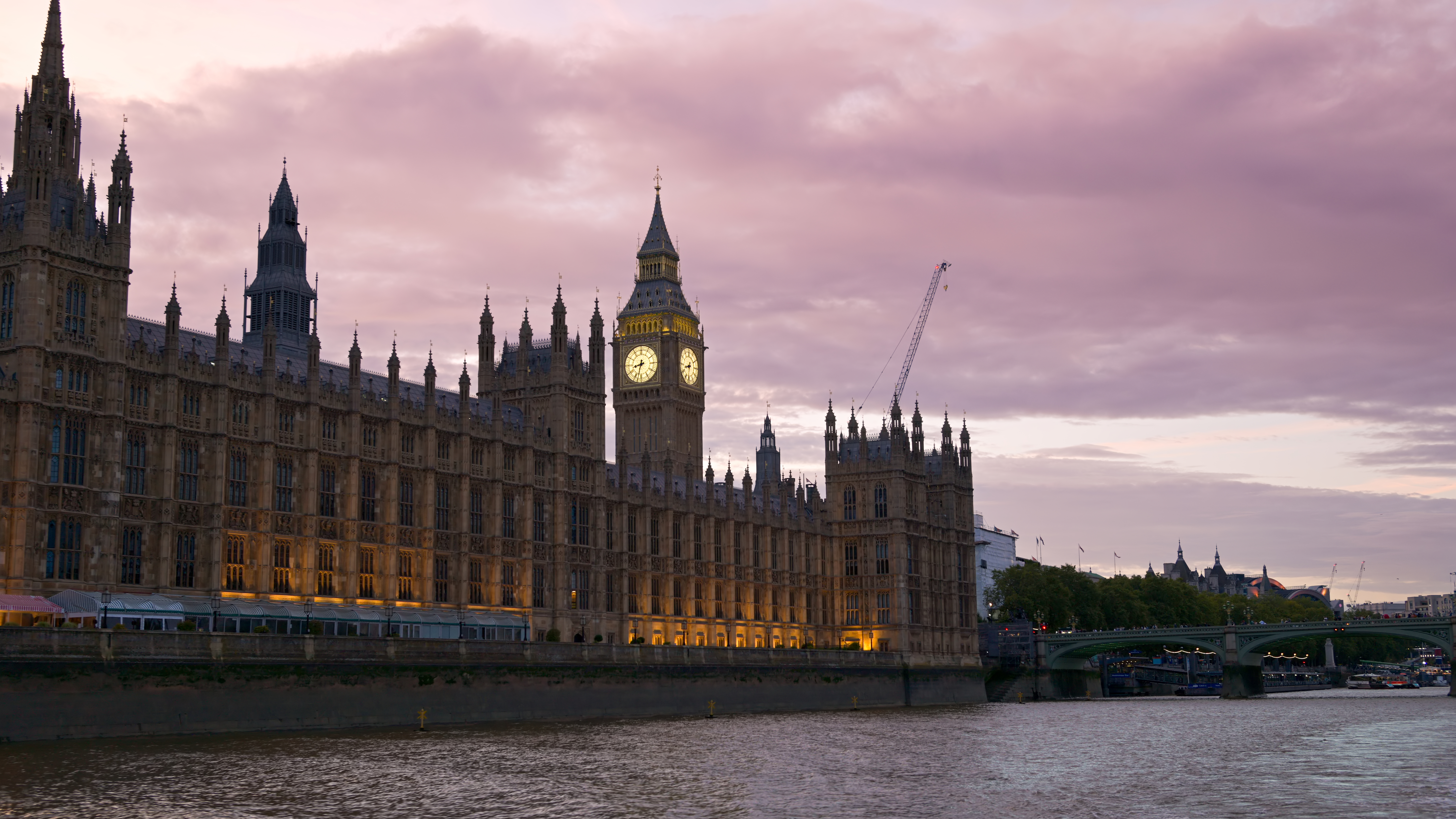 View of London from a floating boat on the Thames River at sunset, United Kingdom. Westminster Palace and Elizabeth Tower